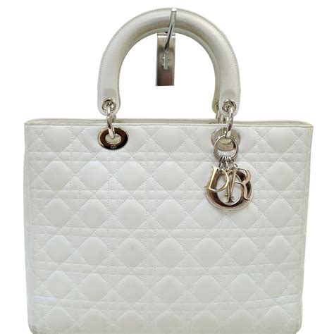 white leather christian dior handbag with single shoulder srap|Christian Dior boutique handbags.